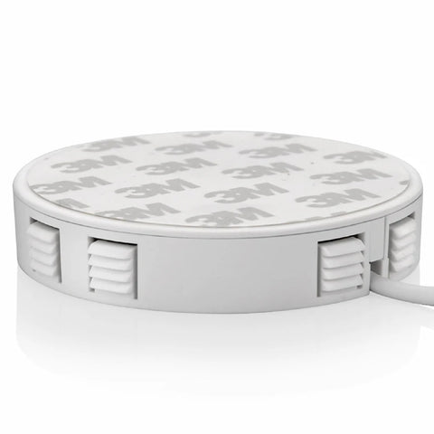 White round device with textured side grips and a printed logo on top, connected by a cable.