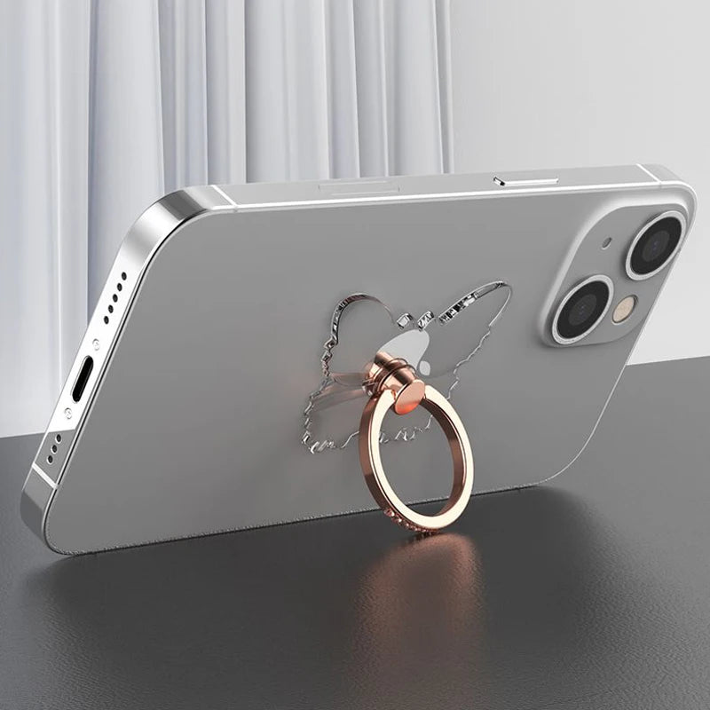 Silver smartphone with butterfly-shaped ring holder, dual cameras, and sleek design.
