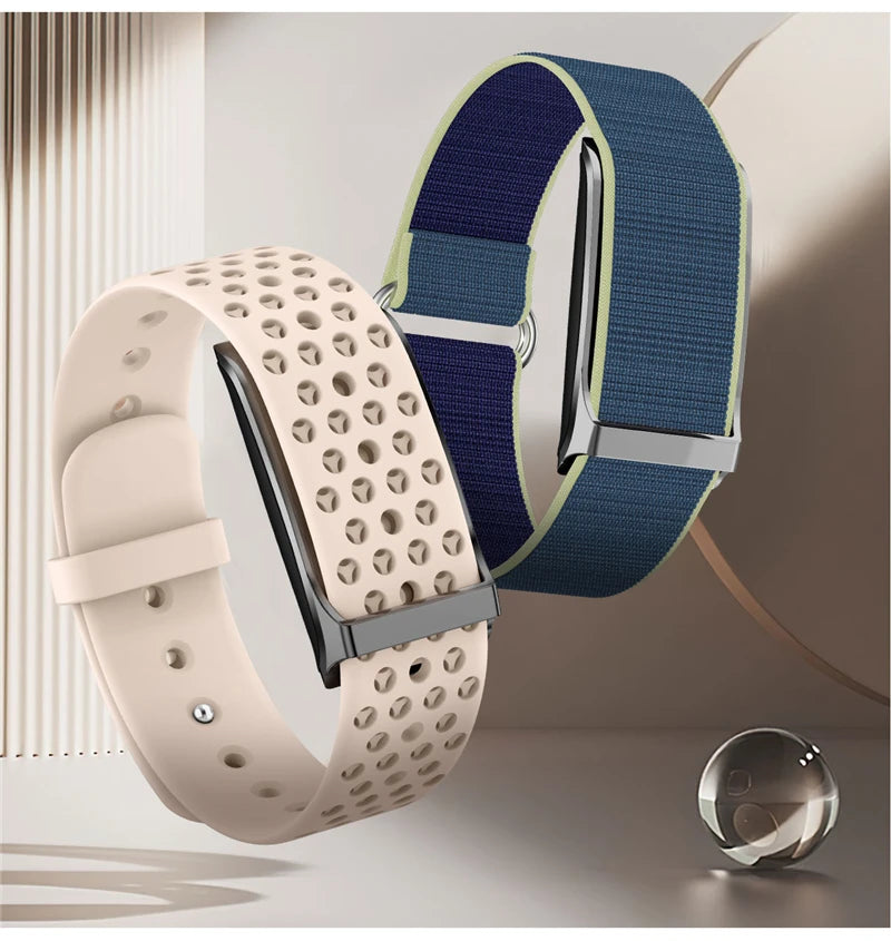 Two smartwatches: one with a beige perforated strap, the other with a blue fabric strap.