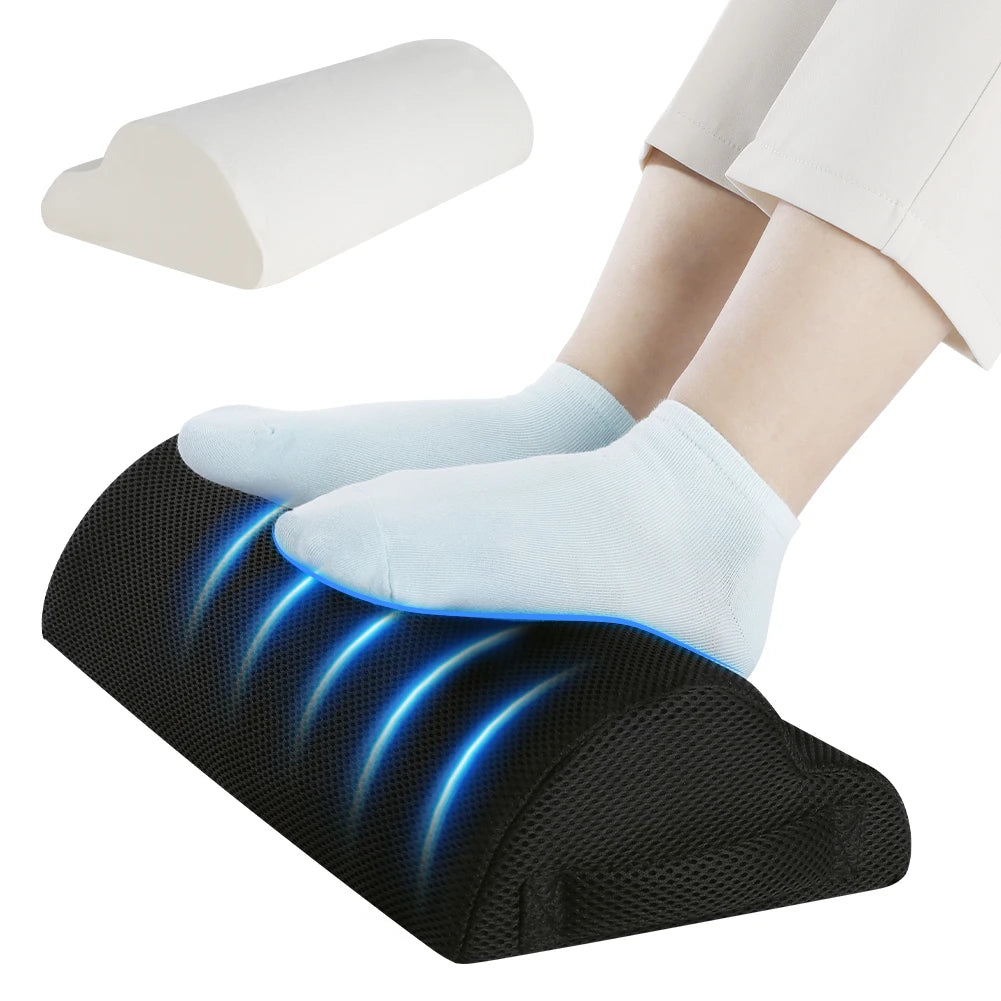 Feet in light blue socks on a curved black footrest with glowing blue stripes; a white cushion above.